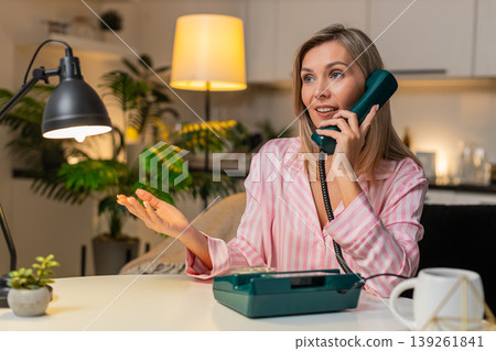 Adult woman hotline operator with retro corded phone listens asks clarifies finds solution tonight 139261841