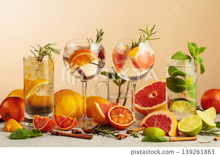 Mojito and various gin and tonic cocktails on a beige background. Mojito and various gin and tonic cocktails on a beige background. 139261863