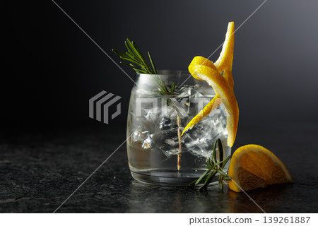 Gin and tonick cocktail in a fogged up glass on a black background. Gin and tonick cocktail in a fogged up glass on a black background. 139261887