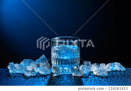Vodka and crushed ice on a black table. Vodka and crushed ice on a black table. 139261913
