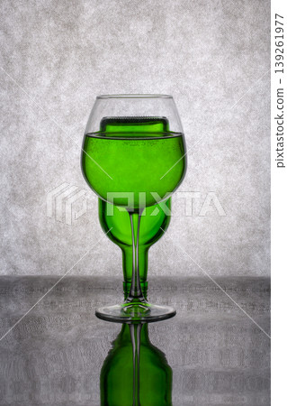 Still life with a green vase and a glass of liquid Still life with a green vase and a glass of liquid 139261977