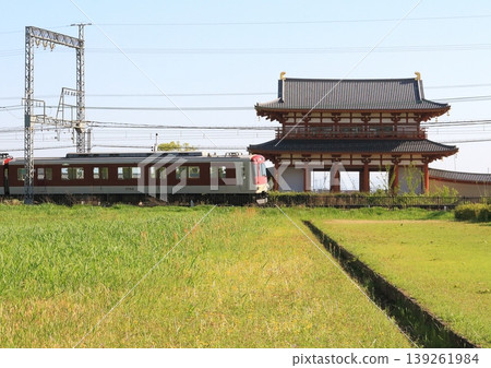 A Kintetsu Nara Line train runs in front of the reconstructed Suzaku Gate at the Nara Heijo Palace Site, a World Heritage Site. A Kintetsu Nara Line train runs in front of the reconstructed Suzaku Gate at the Nara Heijo Palace Site, a World Heritage Site. 139261984