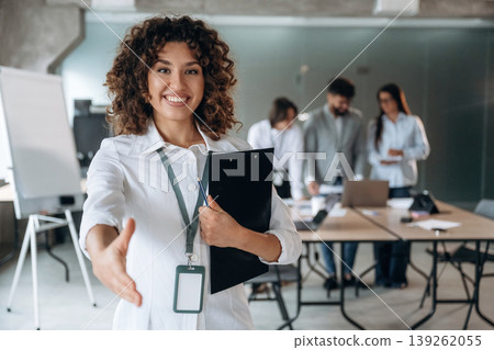 Giving a hand to shake. Group of people are working in the office together as a team Giving a hand to shake. Group of people are working in the office together as a team 139262055
