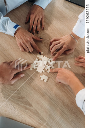 Focused top view of office workers that are playing puzzle game, conception of success 139262233