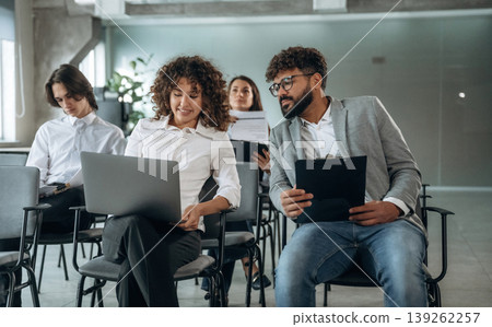 Two employees are talking to each other. People are sitting on the meeting, education presentation, business conception 139262257