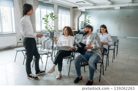 Guy is talking to a man. People are sitting on the meeting, education presentation, business conception 139262263