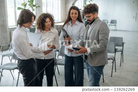At business meeting. Group of people are working in the office together as a team At business meeting. Group of people are working in the office together as a team 139262269