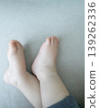 A child's feet relaxing on a piece of cloth 139262336