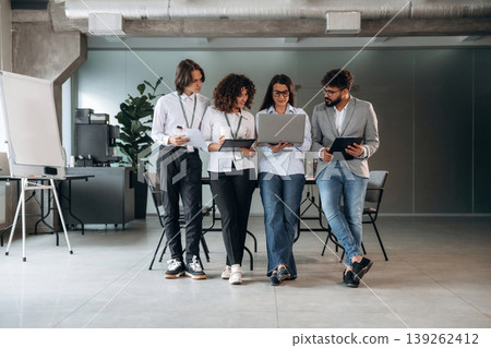 Reading information. Group of people are working in the office together as a team Reading information. Group of people are working in the office together as a team 139262412