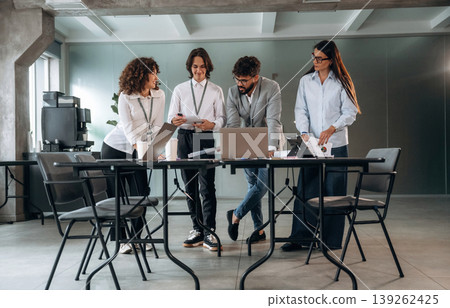 Having a conversation. Group of people are working in the office together as a team Having a conversation. Group of people are working in the office together as a team 139262425