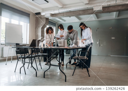 Natural lighting. Group of people are working in the office together as a team Natural lighting. Group of people are working in the office together as a team 139262426