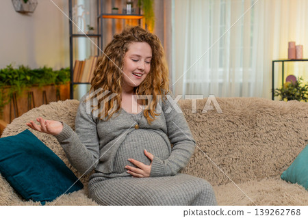 Pregnant young woman talking to belly at home gently touching bonding with baby emotional connection Pregnant young woman talking to belly at home gently touching bonding with baby emotional connection 139262768