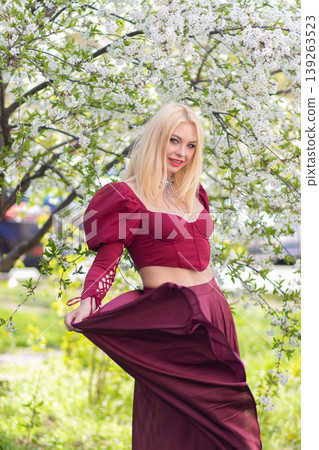Smiling Blonde Woman Swinging Burgundy Skirt In Spring Smiling Blonde Woman Swinging Burgundy Skirt In Spring 139263523