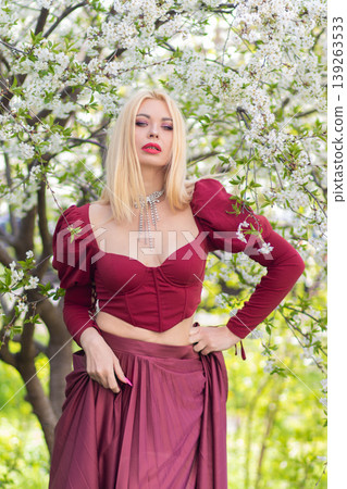 Blonde Woman Leaning Forward Under Spring Blossoms Blonde Woman Leaning Forward Under Spring Blossoms 139263533