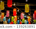 Celestial Canopy: A mesmerizing display of vibrant paper lanterns, illuminated by twinkling bulbs, casts a warm, inviting glow against a deep twilight.  139263891