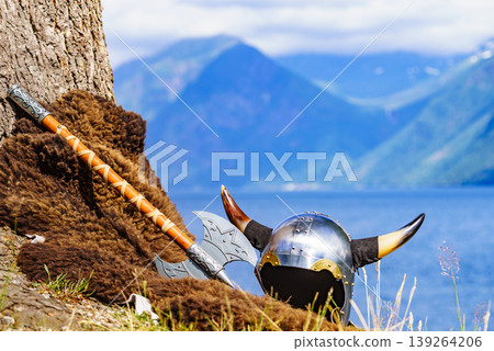 Viking helmet on fjord shore, Norway Viking helmet on fjord shore, Norway 139264206