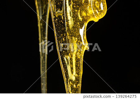 Creative honey swirl on black background. Creative honey swirl on black background. 139264275