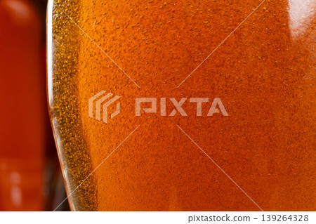 Abstract background of golden maple syrup texture Abstract background of golden maple syrup texture 139264328