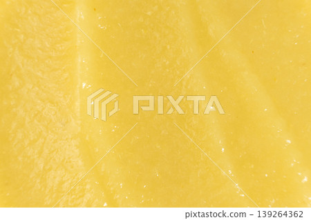 Macro texture of smooth organic apple puree top view. Macro texture of smooth organic apple puree top view. 139264362