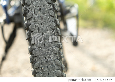 Close-up of old cracked bicycle tire tread. Close-up of old cracked bicycle tire tread. 139264376