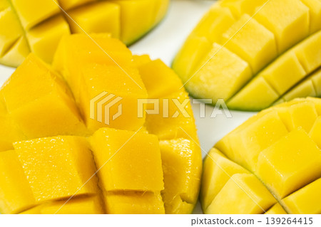 Juicy mango halves with cube cut pattern. Juicy mango halves with cube cut pattern. 139264415