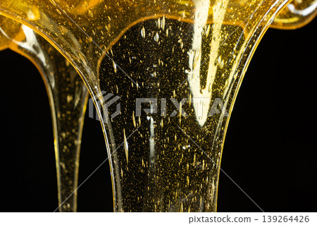 Premium organic honey texture with bubbles macro. 139264426