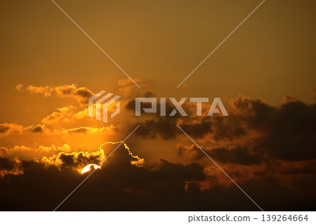 Dramatic Sunset Sky with Golden Sun and Dark Clouds. Intense, beautiful nature background. Dramatic Sunset Sky with Golden Sun and Dark Clouds. Intense, beautiful nature background. 139264664