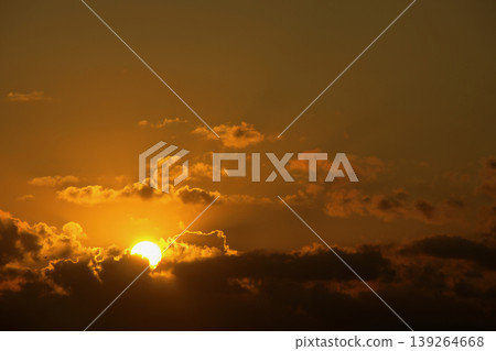 Dramatic Sunset Sky with Golden Sun and Dark Clouds. Intense, beautiful nature background. Dramatic Sunset Sky with Golden Sun and Dark Clouds. Intense, beautiful nature background. 139264668