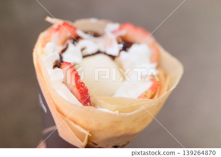 A close-up view from above of a crepe filled with daifuku ice cream. A close-up view from above of a crepe filled with daifuku ice cream. 139264870