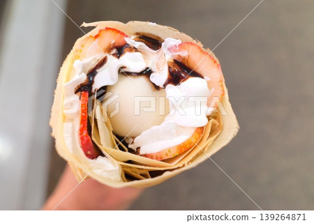 A close-up view from above of a crepe filled with daifuku ice cream. 139264871