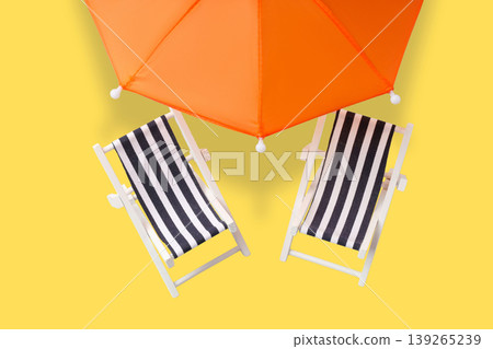 Beach chairs and an umbrella set up for summer relaxation 139265239
