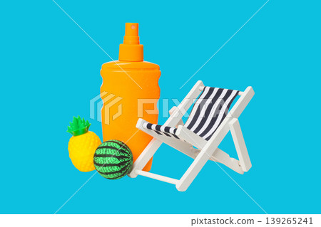 A sunblock bottle, chair, and colorful toys on a bright backdrop A sunblock bottle, chair, and colorful toys on a bright backdrop 139265241