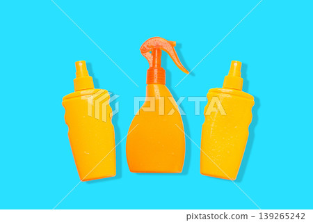 Three mustard bottles arranged in a circle on a blue backdrop 139265242