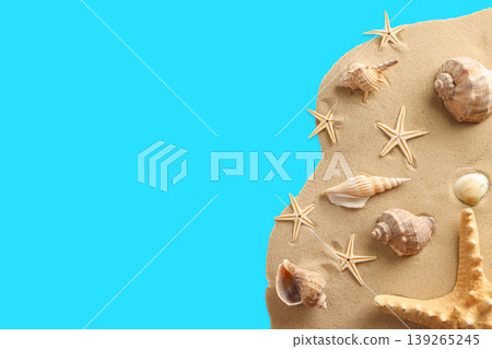 Collection of seashells and starfish on sandy surface 139265245