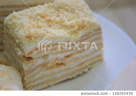 Delicious homemade Napoleon cake with delicate layers and custard cream closeup 139265439