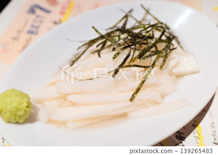 Nagaimo (Japanese yam) and shredded nori (seaweed) served on a white plate. Nagaimo (Japanese yam) and shredded nori (seaweed) served on a white plate. 139265483