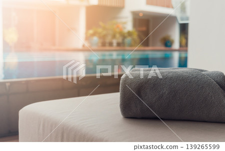New towels on a sun-bed near a swimming pool. New towels on a sun-bed near a swimming pool. 139265599