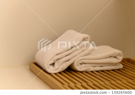 white towel on wooden board in bathroom. hygiene, shower, bath, freshness concept white towel on wooden board in bathroom. hygiene, shower, bath, freshness concept 139265600