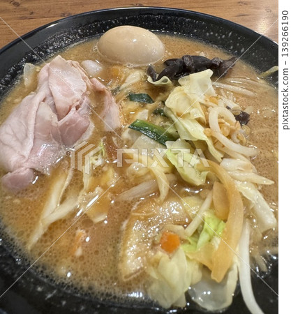 A hearty, stamina-boosting ramen dish topped with plenty of vegetables and large slices of char siu pork. A close-up of the generously portioned noodle dish and how to eat it. A hearty, stamina-boosting ramen dish topped with plenty of vegetables and large slices of char siu pork. A close-up of the generously portioned noodle dish and how to eat it. 139266190