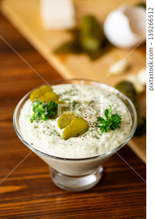 Fresh rustic yogurt sauce with herbs on wooden table 139266512