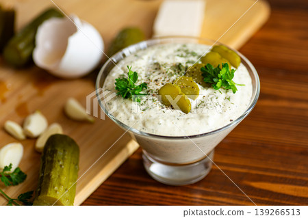 Traditional creamy cucumber garlic dressing in glass bowl 139266513