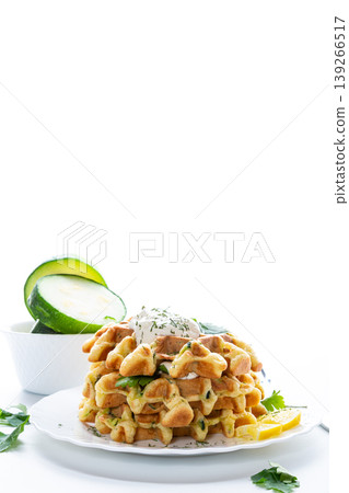 healthy zucchini waffles with sour cream on white plate 139266517