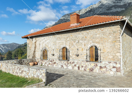 Ancient stone house with a roof of tile close-up 139266602