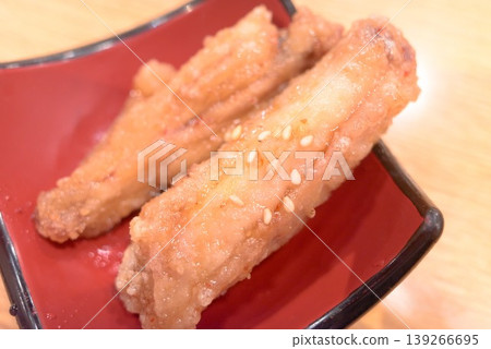 Sweet and spicy fried chicken wings served on a small red plate Sweet and spicy fried chicken wings served on a small red plate 139266695