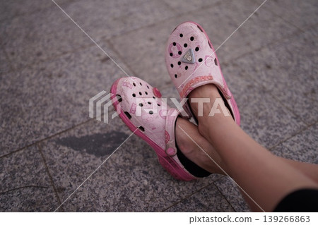 a pink ballet shoes in the feet 139266863