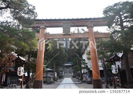 The torii gate and lanterns of Sakurayama Hachimangu Shrine in Takayama City, Gifu Prefecture, Japan, during the morning scene of the Spring Takayama Festival. The torii gate and lanterns of Sakurayama Hachimangu Shrine in Takayama City, Gifu Prefecture, Japan, during the morning scene of the Spring Takayama Festival. 139267714