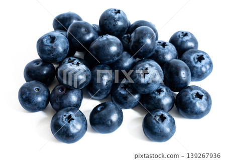 A white background piled high with fresh blueberries, lots of fruit on a white background. 139267936