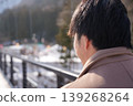 A man heading towards a snow park amidst a snowy landscape. 139268264