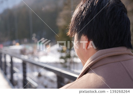 A man heading towards a snow park amidst a snowy landscape. A man heading towards a snow park amidst a snowy landscape. 139268264
