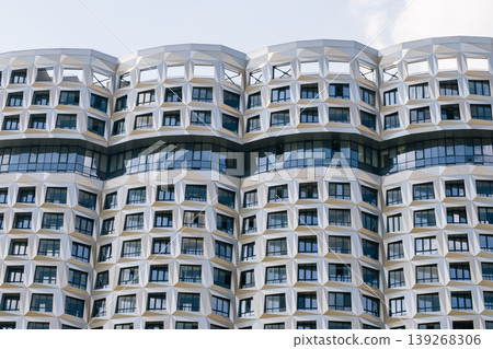 Modern curved building facade with geometric design Modern curved building facade with geometric design 139268306